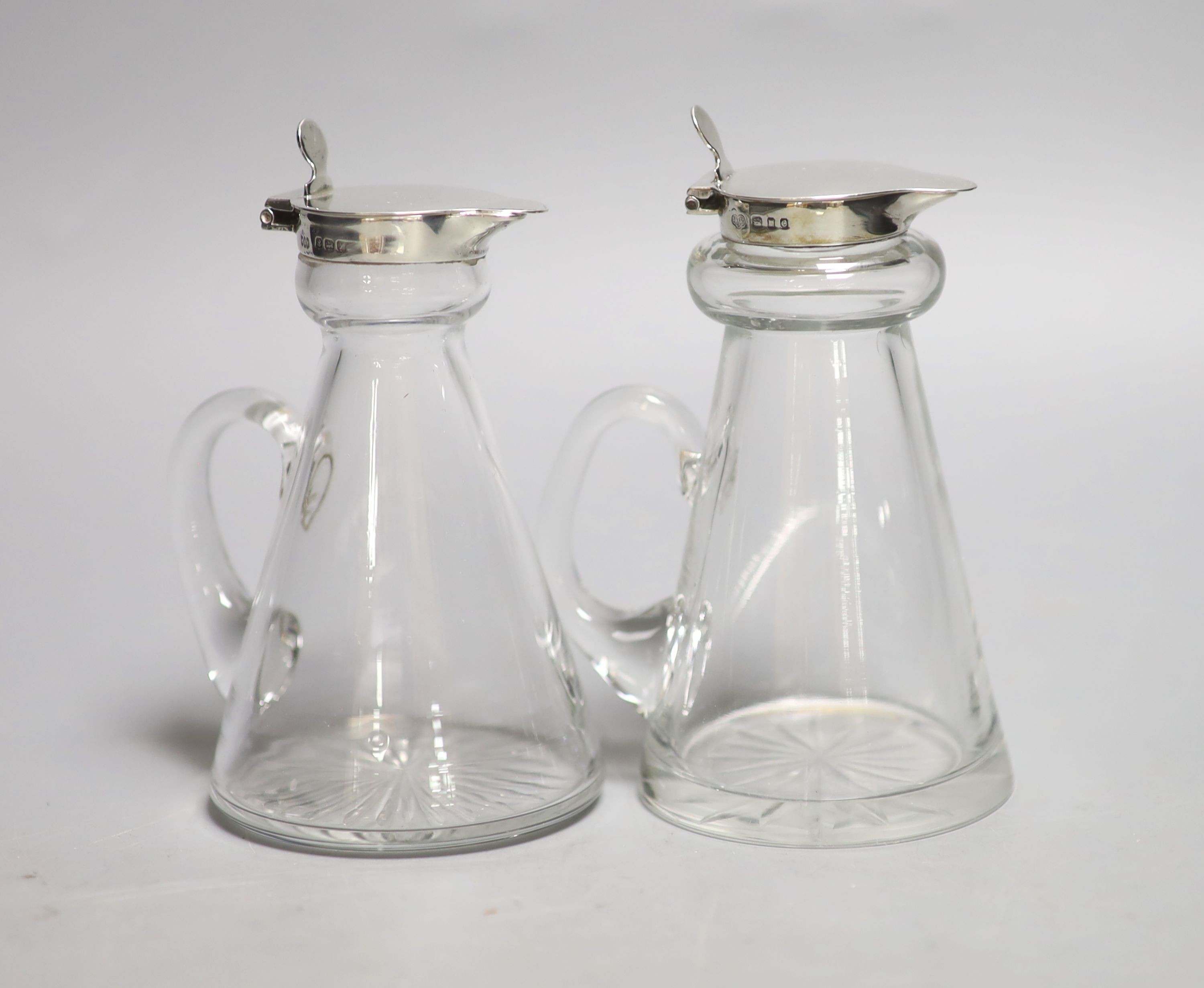 Two 20th century silver mounted whisky tot jugs, Birmingham, 1922 & London, 1938, tallest 11.3cm.